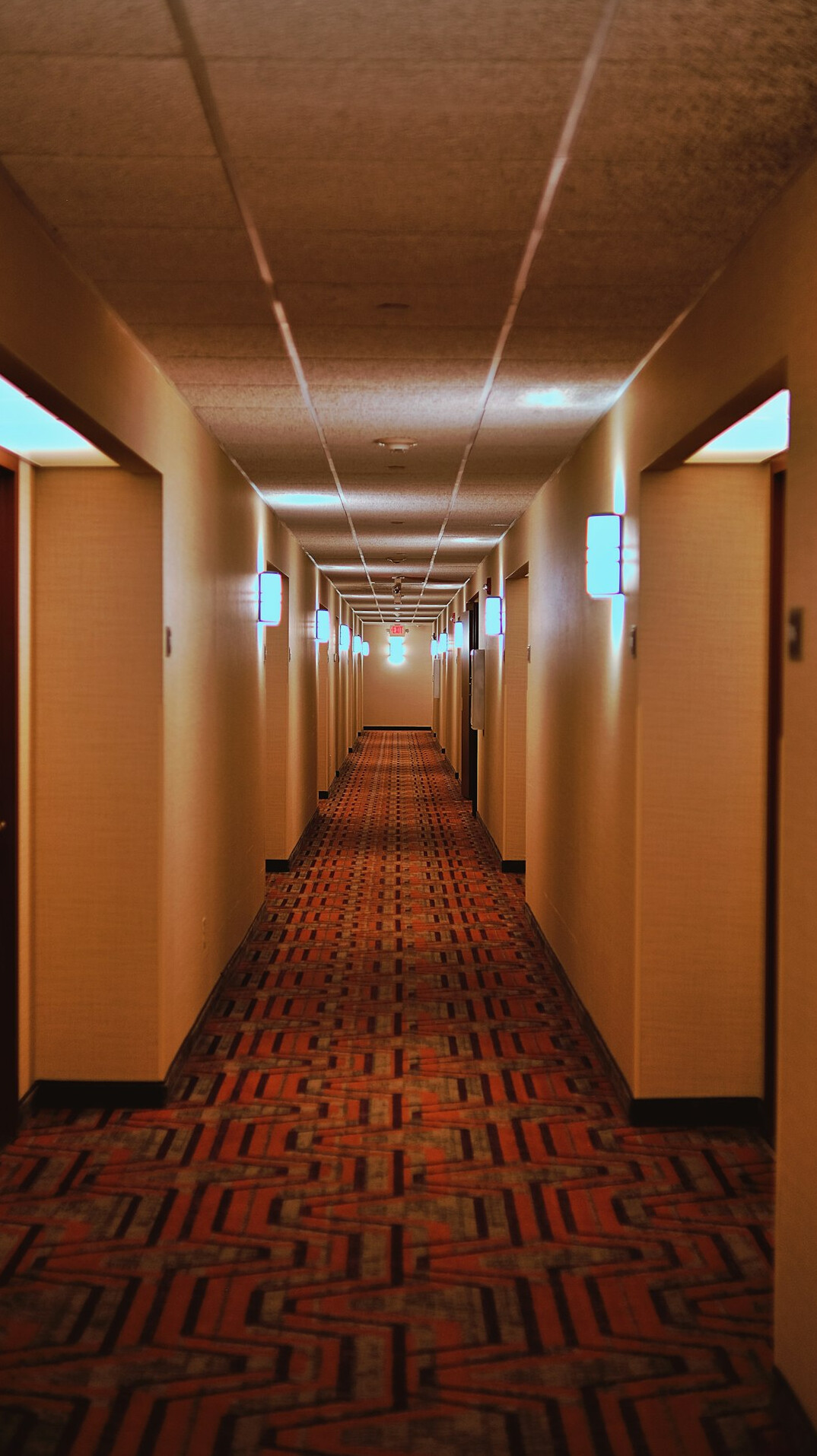Dim television studio corridor with archival wall panels