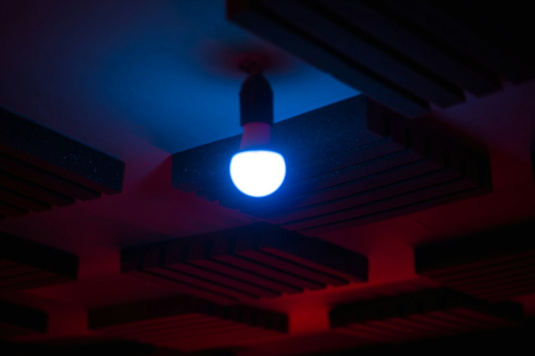 Colorful broadcast studio lighting rig against dark ceiling