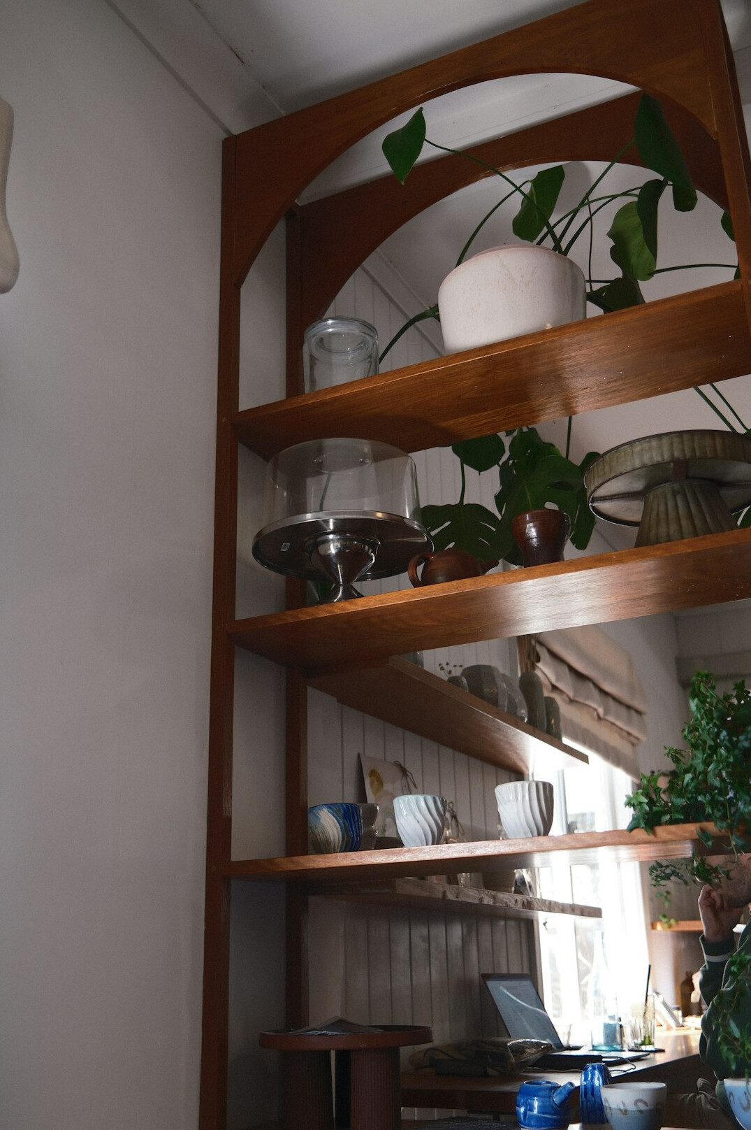 Stacked archival film reels on a wooden shelf